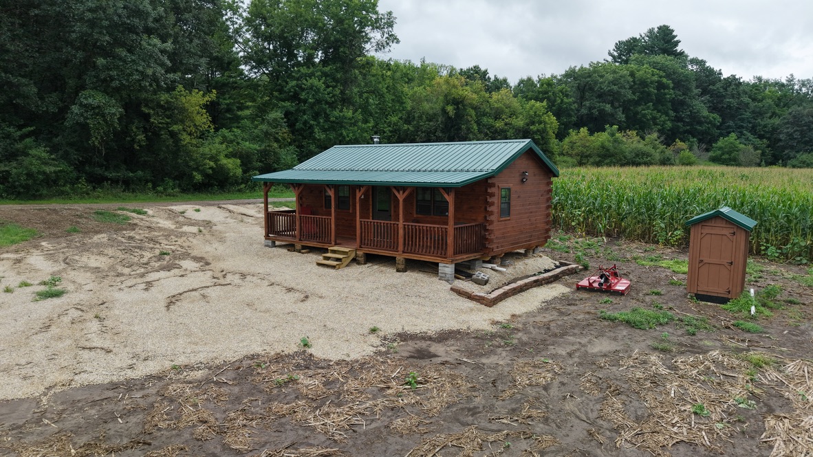 Big River Cabins log cabin with covered porch